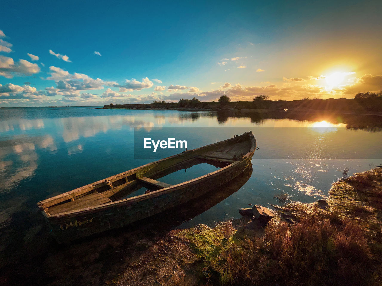 Scenic view of lake against sky during sunset