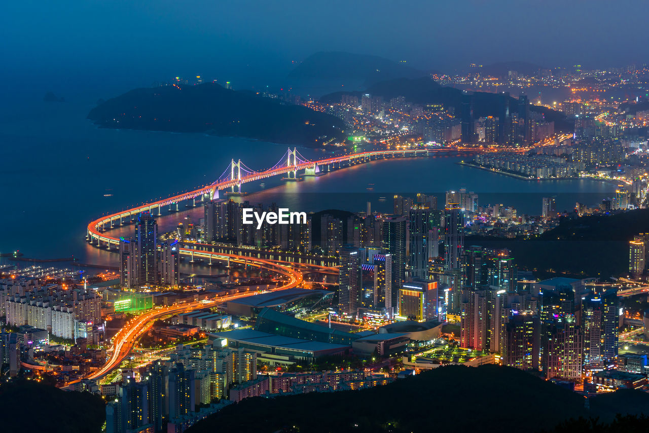 High angle view of illuminated buildings in city at night