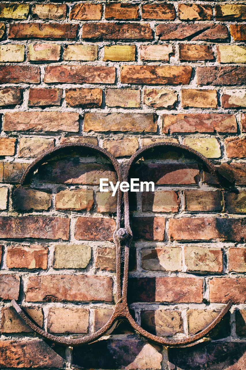 Close-up of metal on brick wall