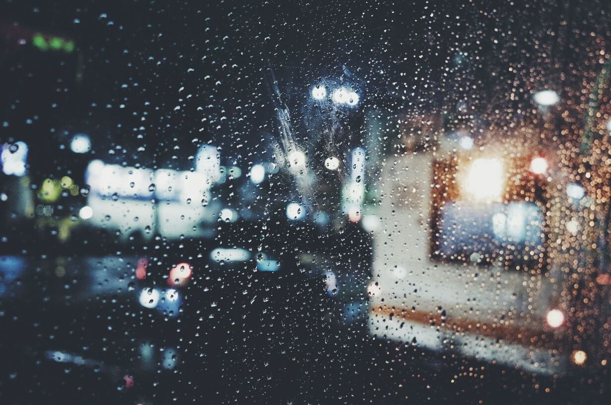 Close-up of water drops on glass at night