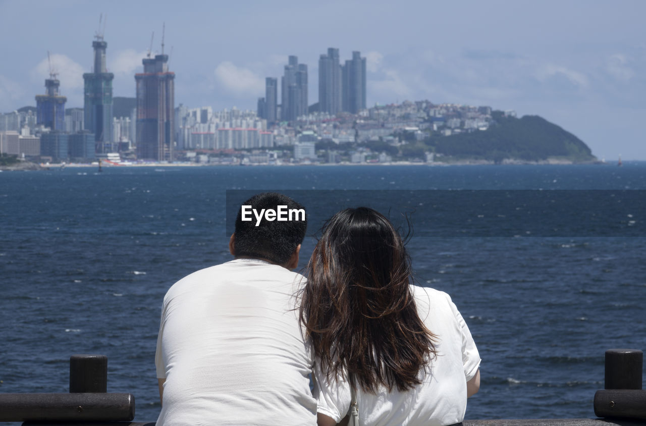 Rear view of couple looking at cityscape