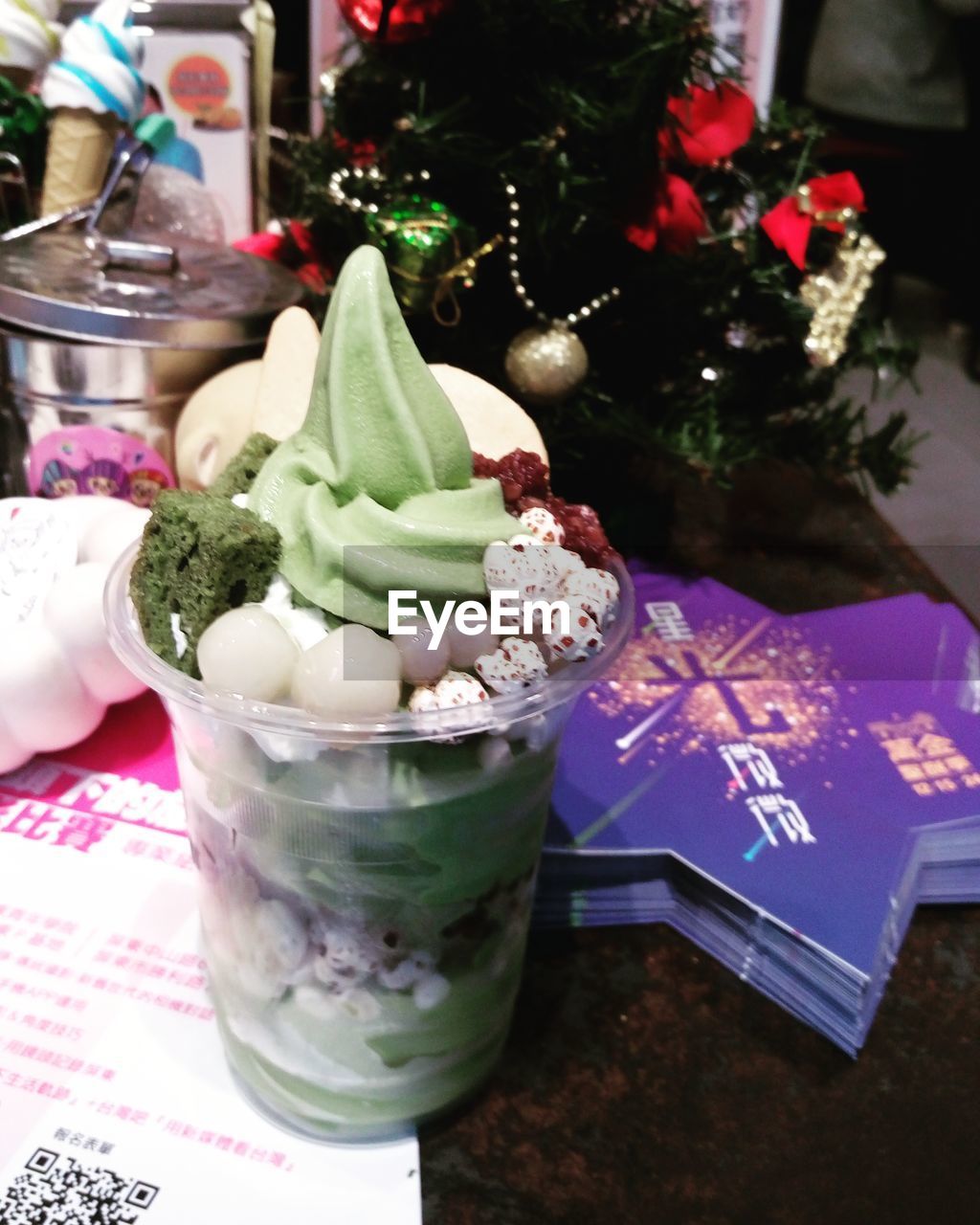 CLOSE-UP OF FRESH ICE CREAM WITH CHRISTMAS LIGHTS ON TABLE