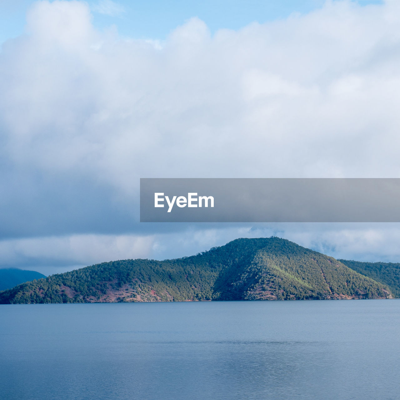 Scenic view of sea and mountains against sky