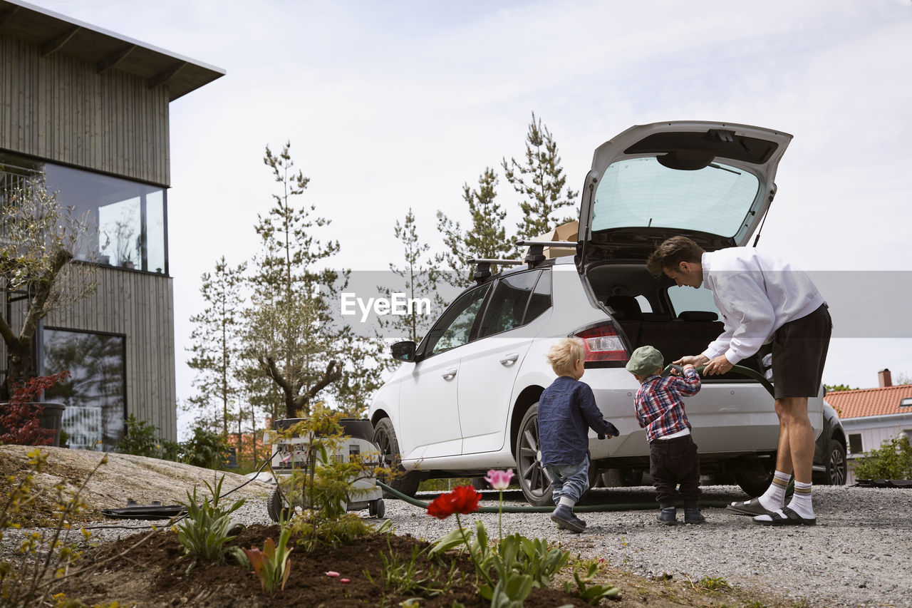 Man vacuuming car boot