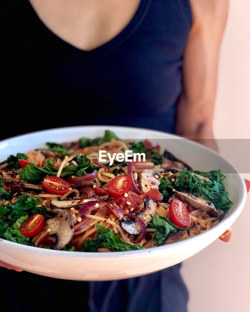 Midsection of woman holding food in plate