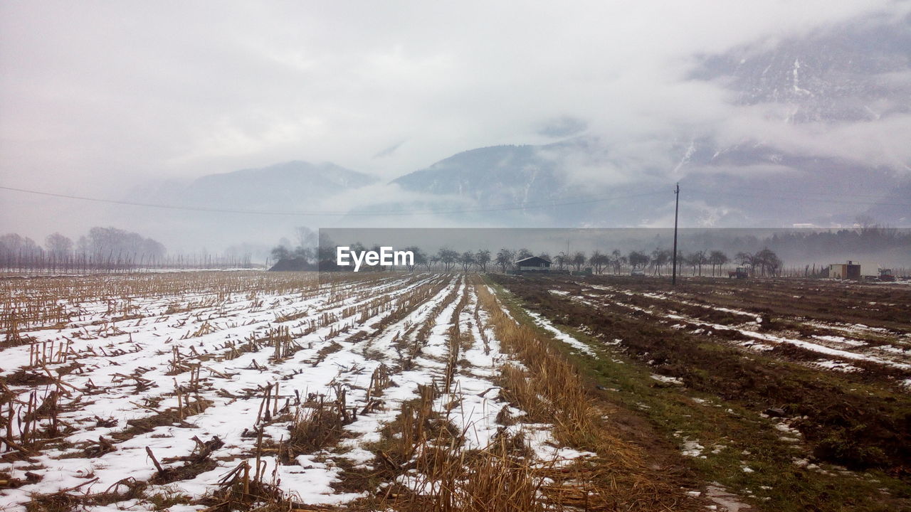 Snow covered landscape against sky