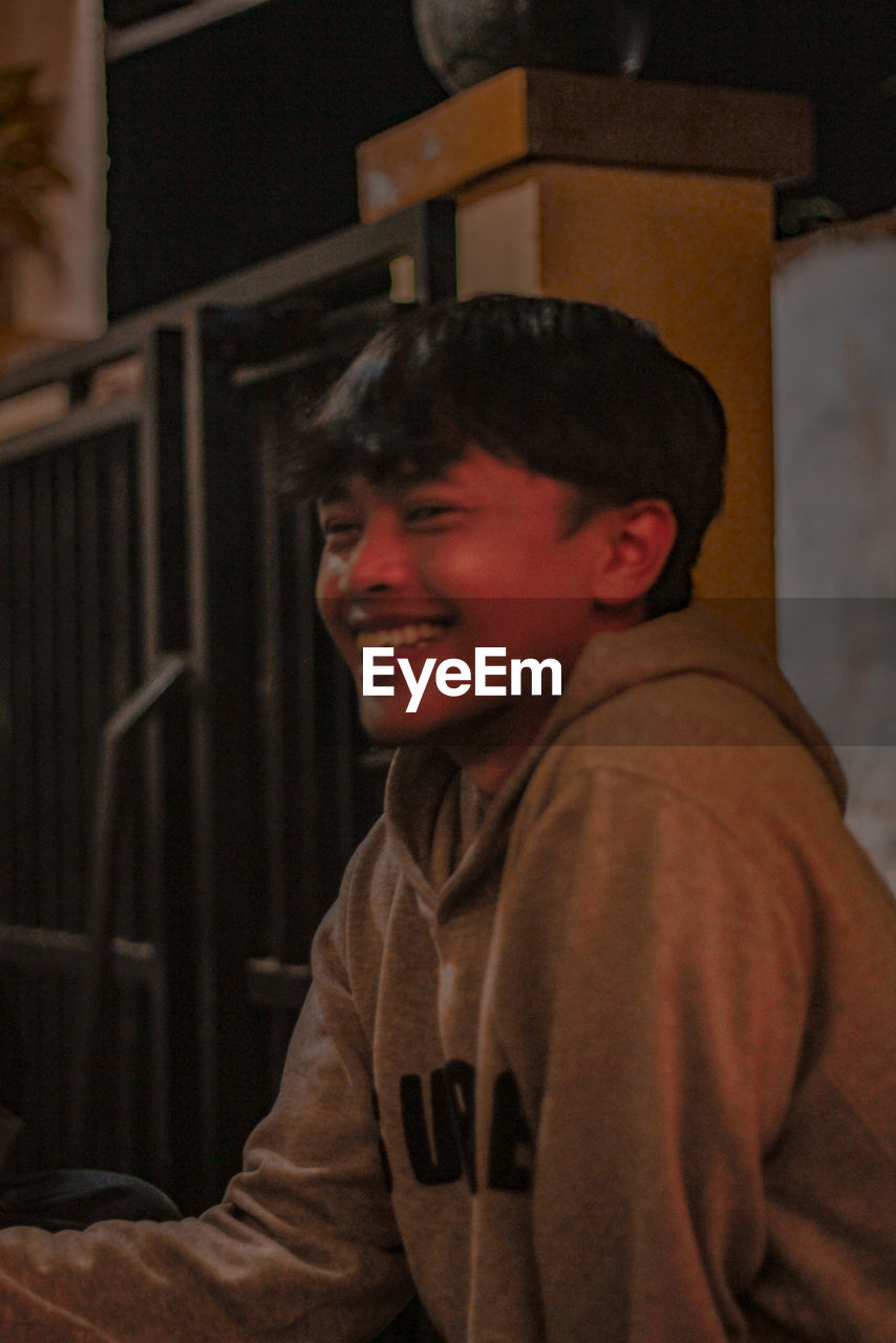 Portrait of smiling boy standing at home