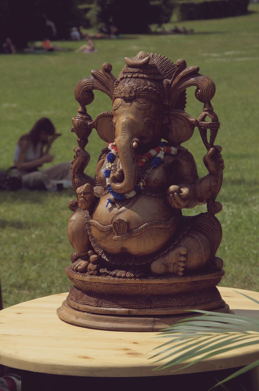 sculpture, statue, representation, art, religion, focus on foreground, no people, human representation, monument, day, grass, belief, creativity, nature, spirituality, craft, animal representation, outdoors, plant, close-up, temple