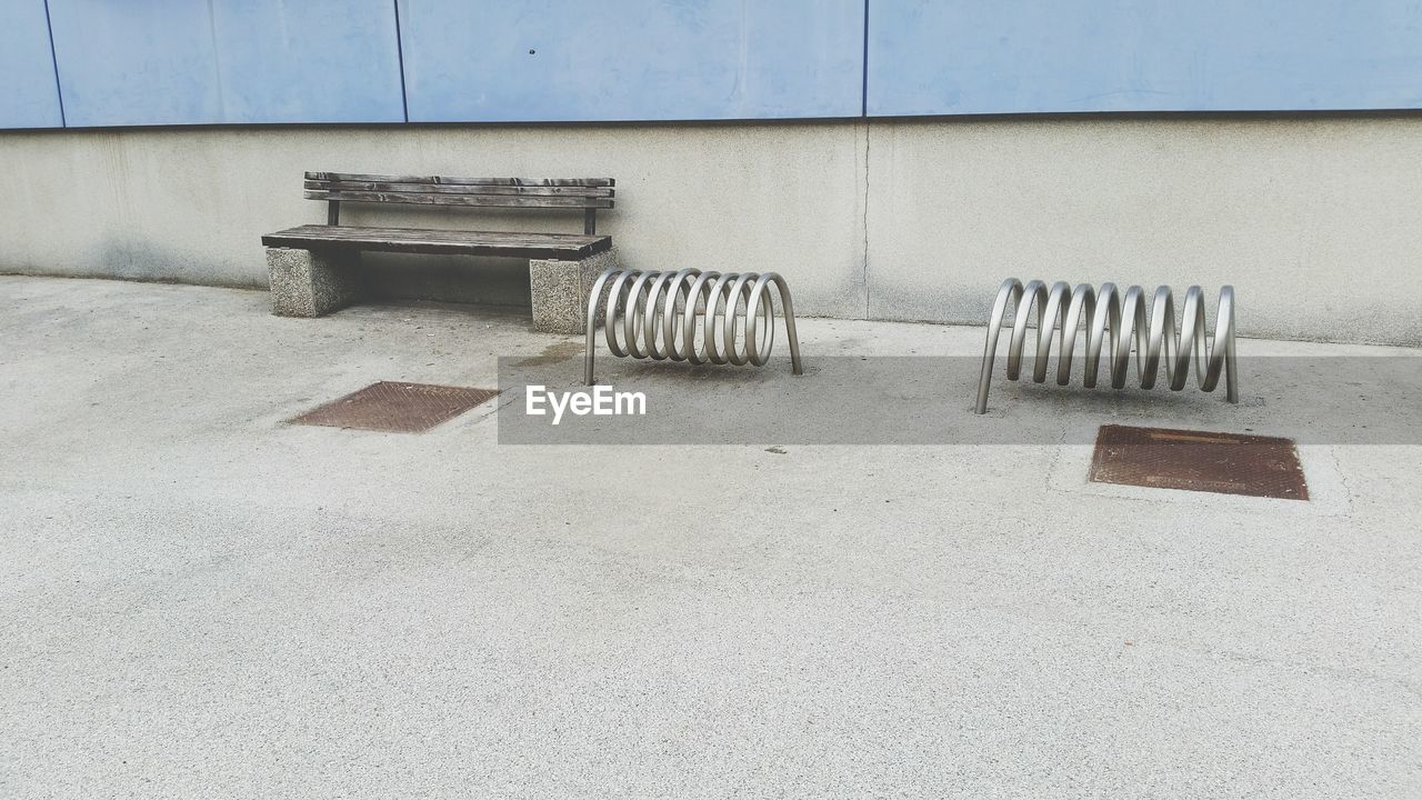 EMPTY CHAIRS AGAINST WALL IN ROW