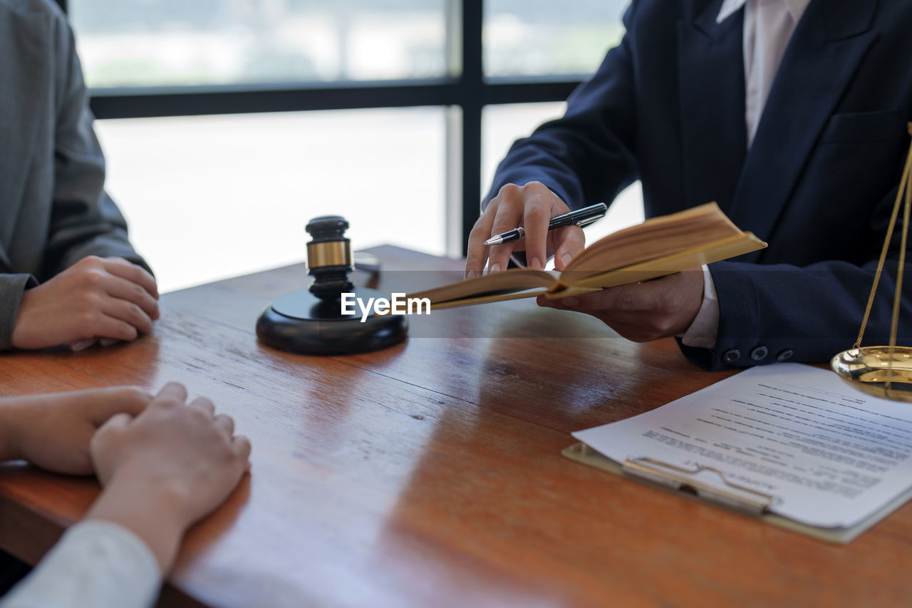 midsection of lawyer working at table