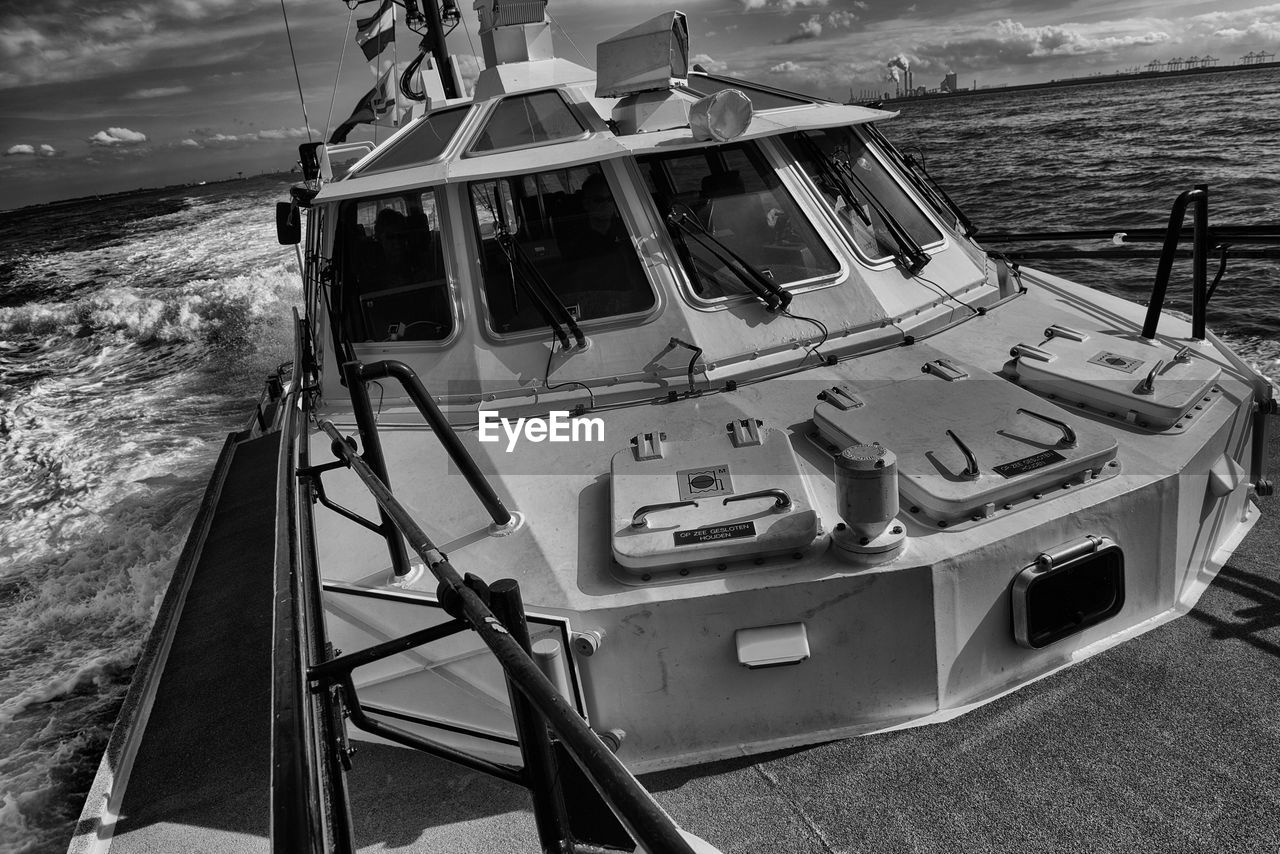 HIGH ANGLE VIEW OF SHIP MOORED ON SEA