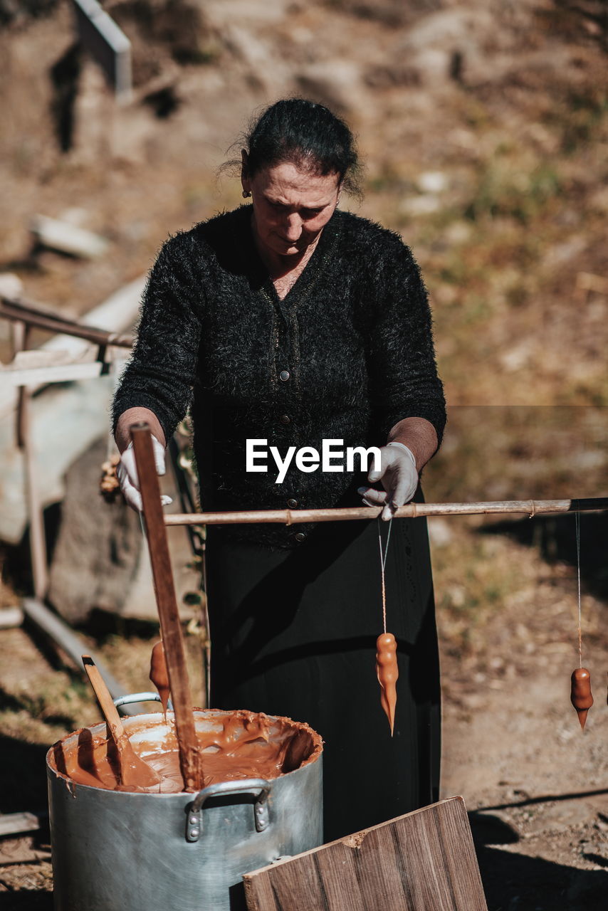 Woman making equipment on field