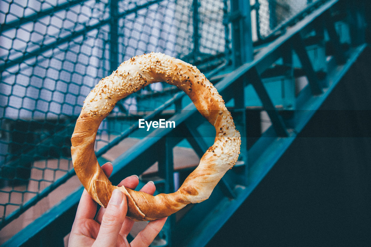 Close-up of a hand holding pretzel