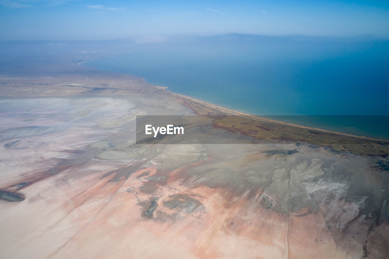 Amazing drone view from above of blue sea water washing rocky shore with mineral formations