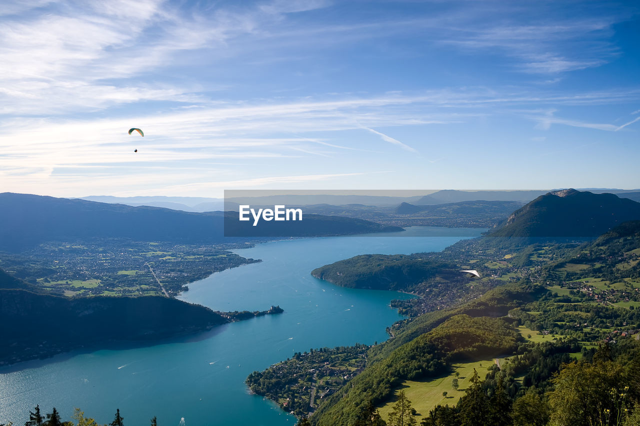 Scenic view of river and mountains against sky