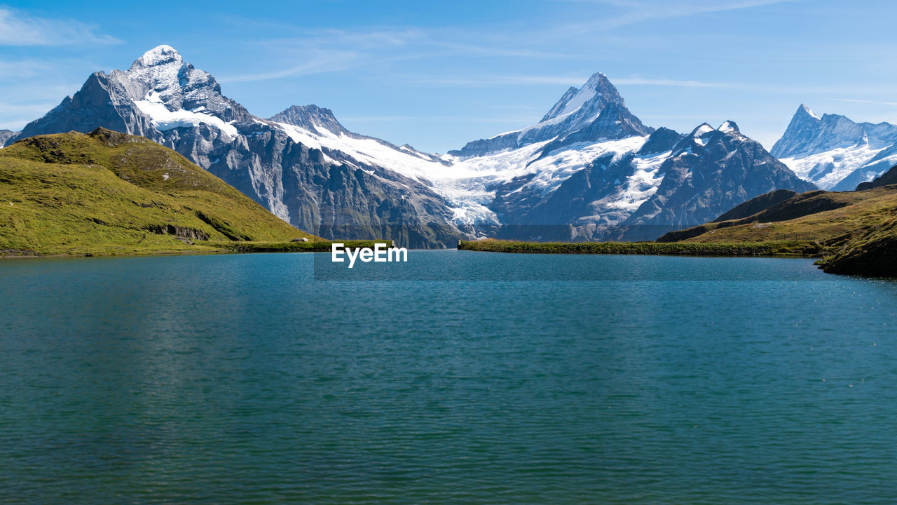 Scenic view of lake and snowcapped mountains against sky