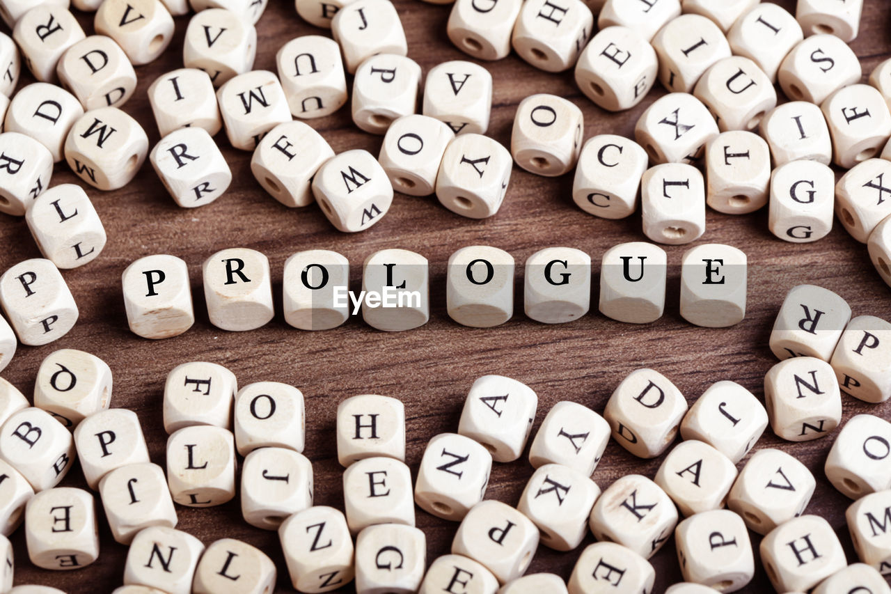 Word prologue in letters on cube dices on table.