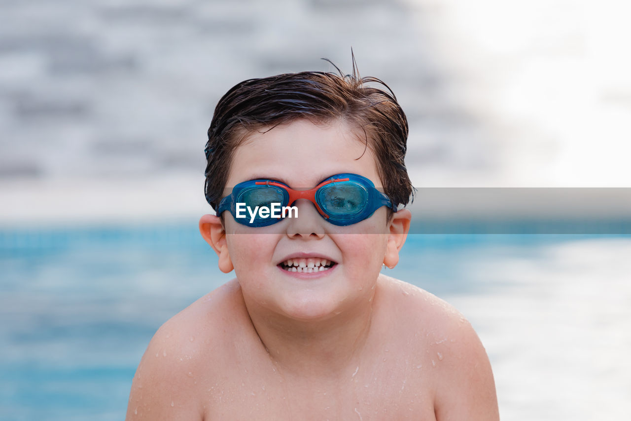 Portrait of smiling boy in swimming pool