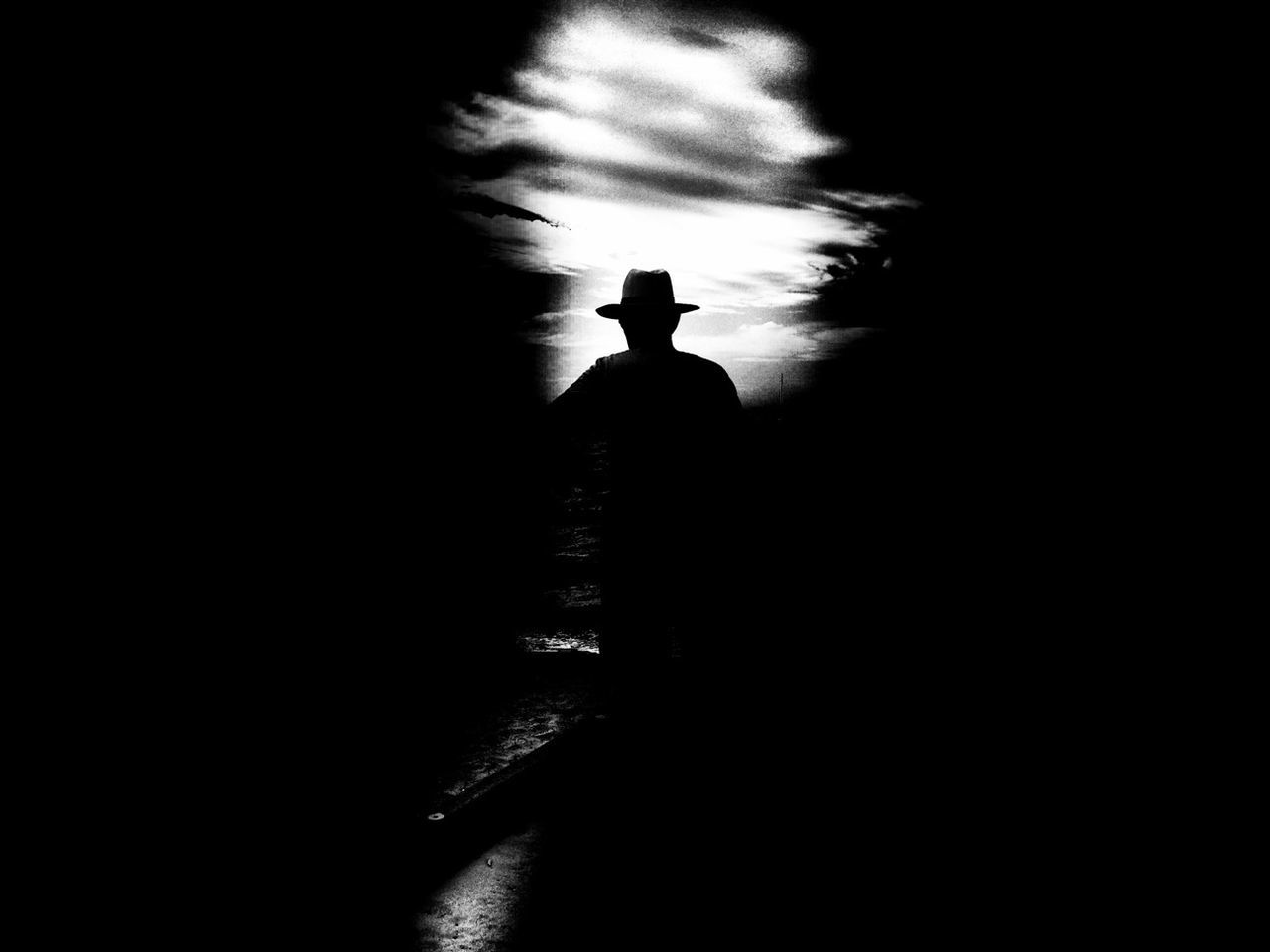 Silhouette of man in hat