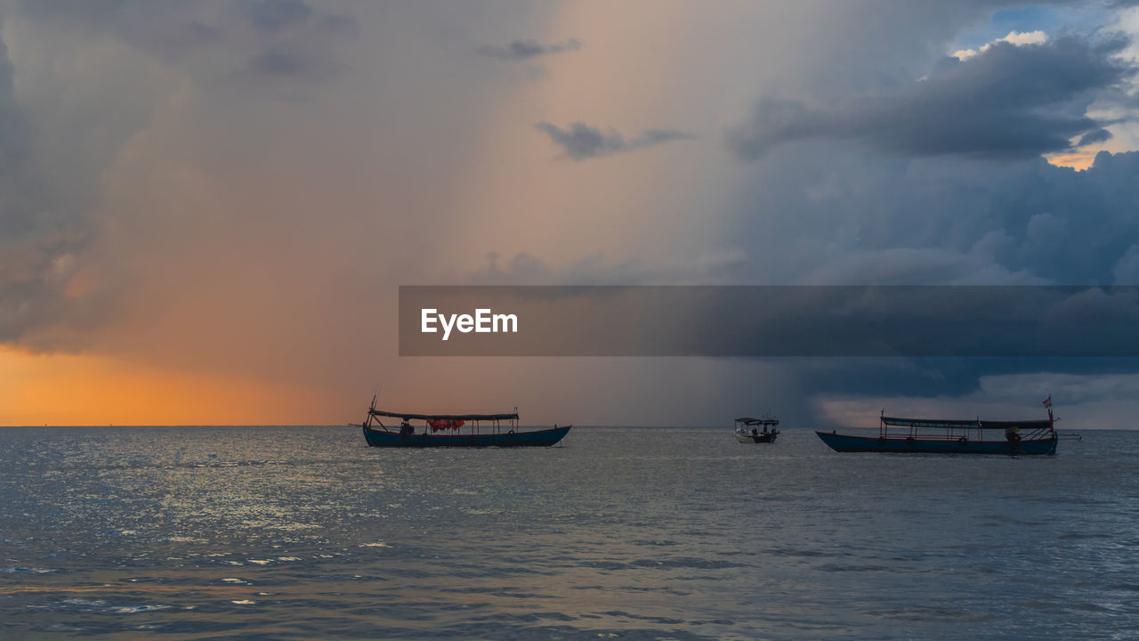 Koh rong island, cambodia at sunrise. strong vibrant colors, boats and ocean