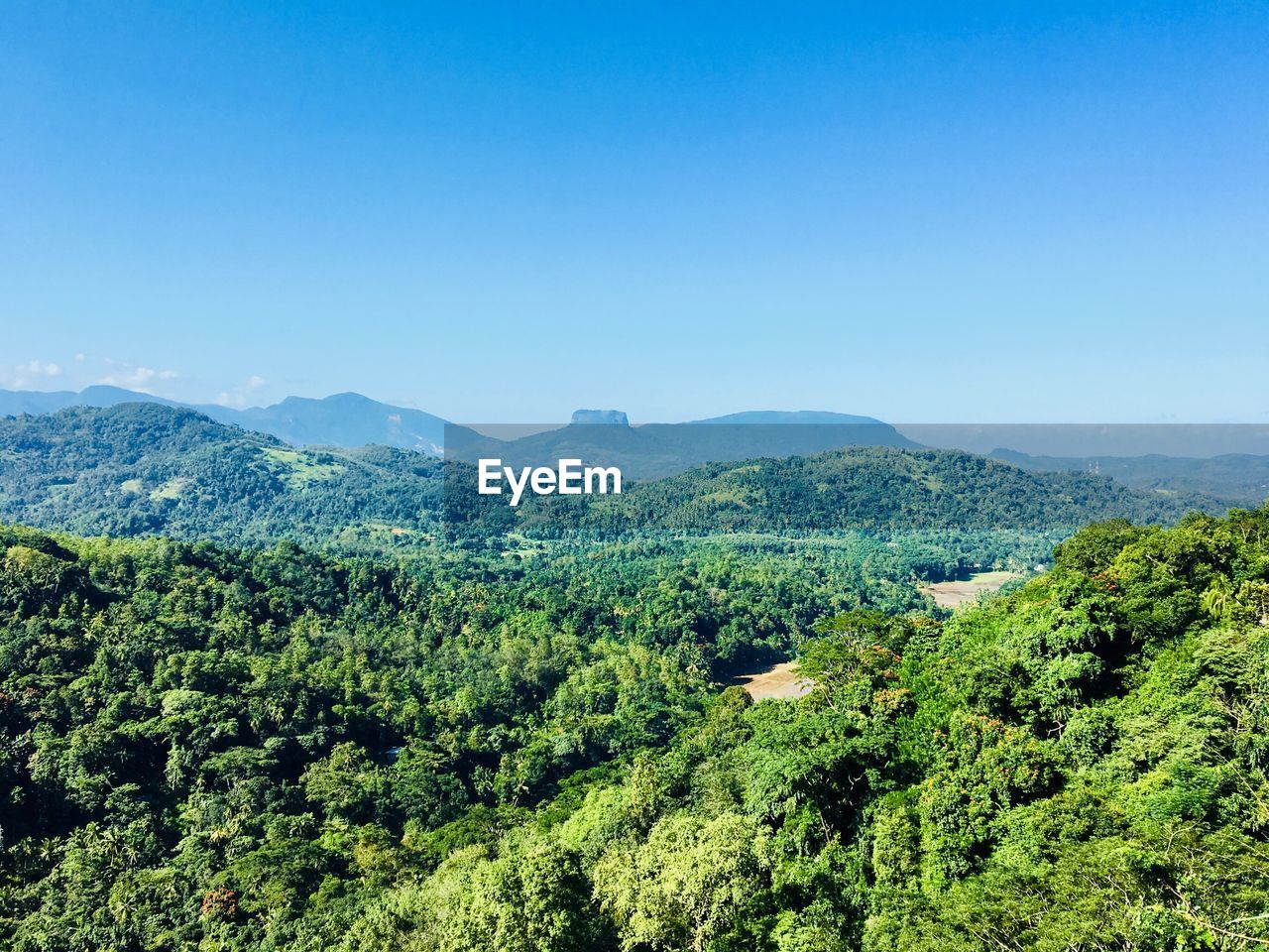 Scenic view of mountains against clear blue sky