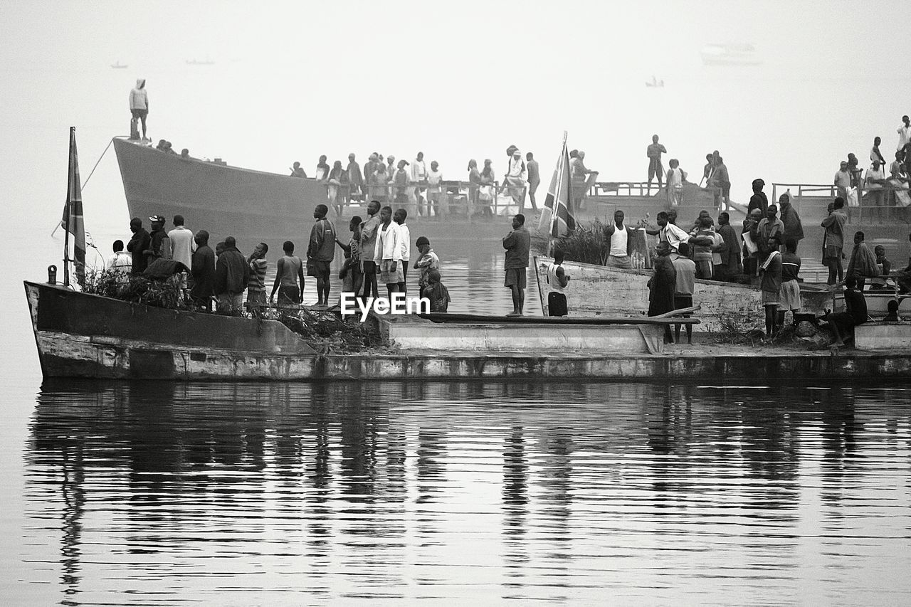 People on boats sailing in sea