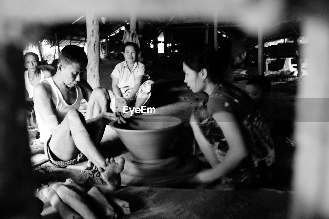 People working on pottery wheel