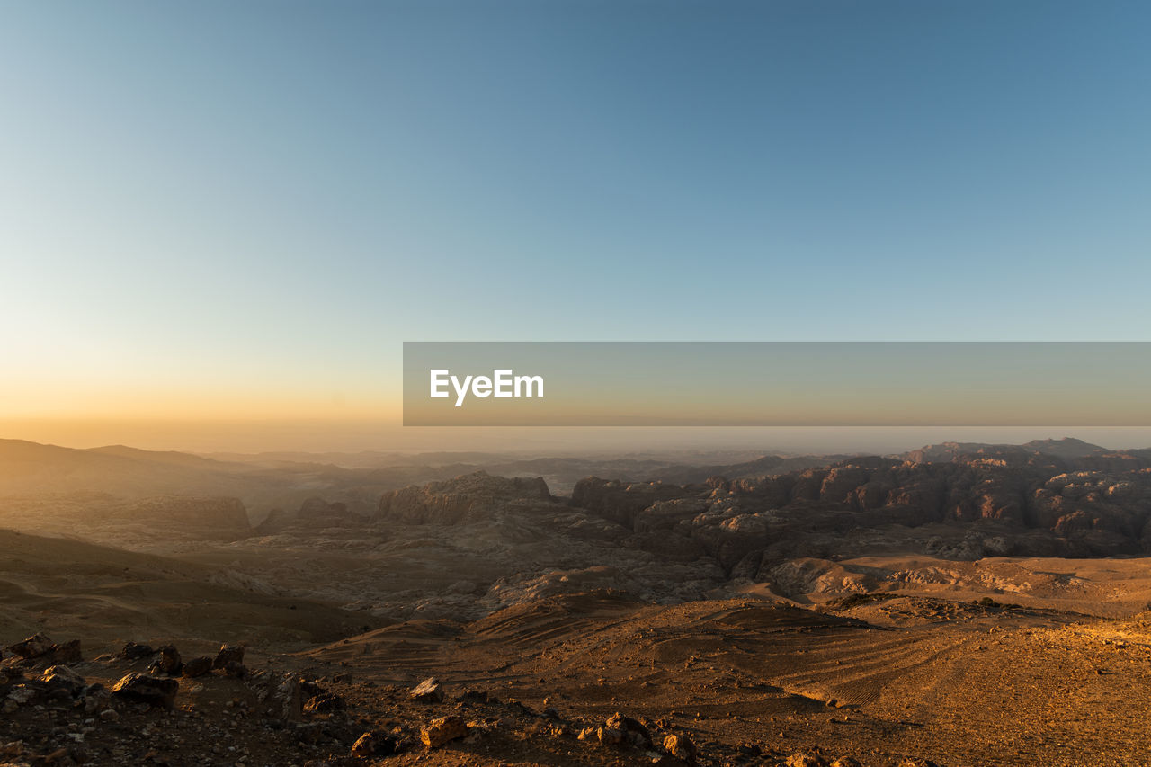 SCENIC VIEW OF LANDSCAPE AGAINST SKY DURING SUNSET