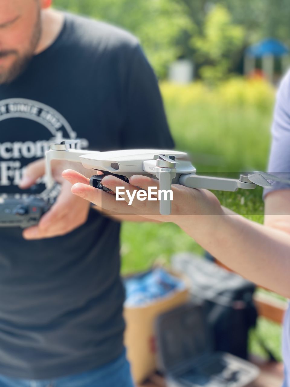 Midsection of man holding drone outdoors