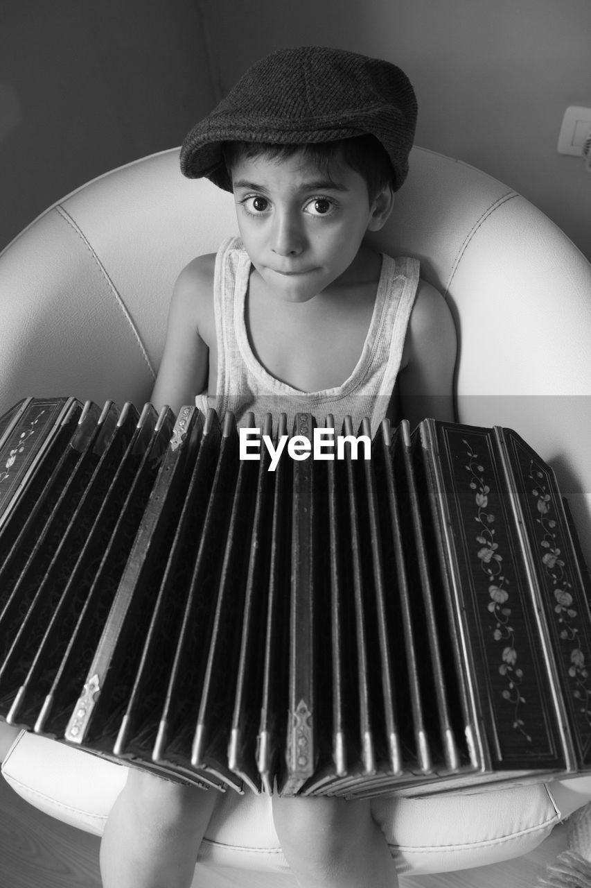 Top view of boy playing bandoneon