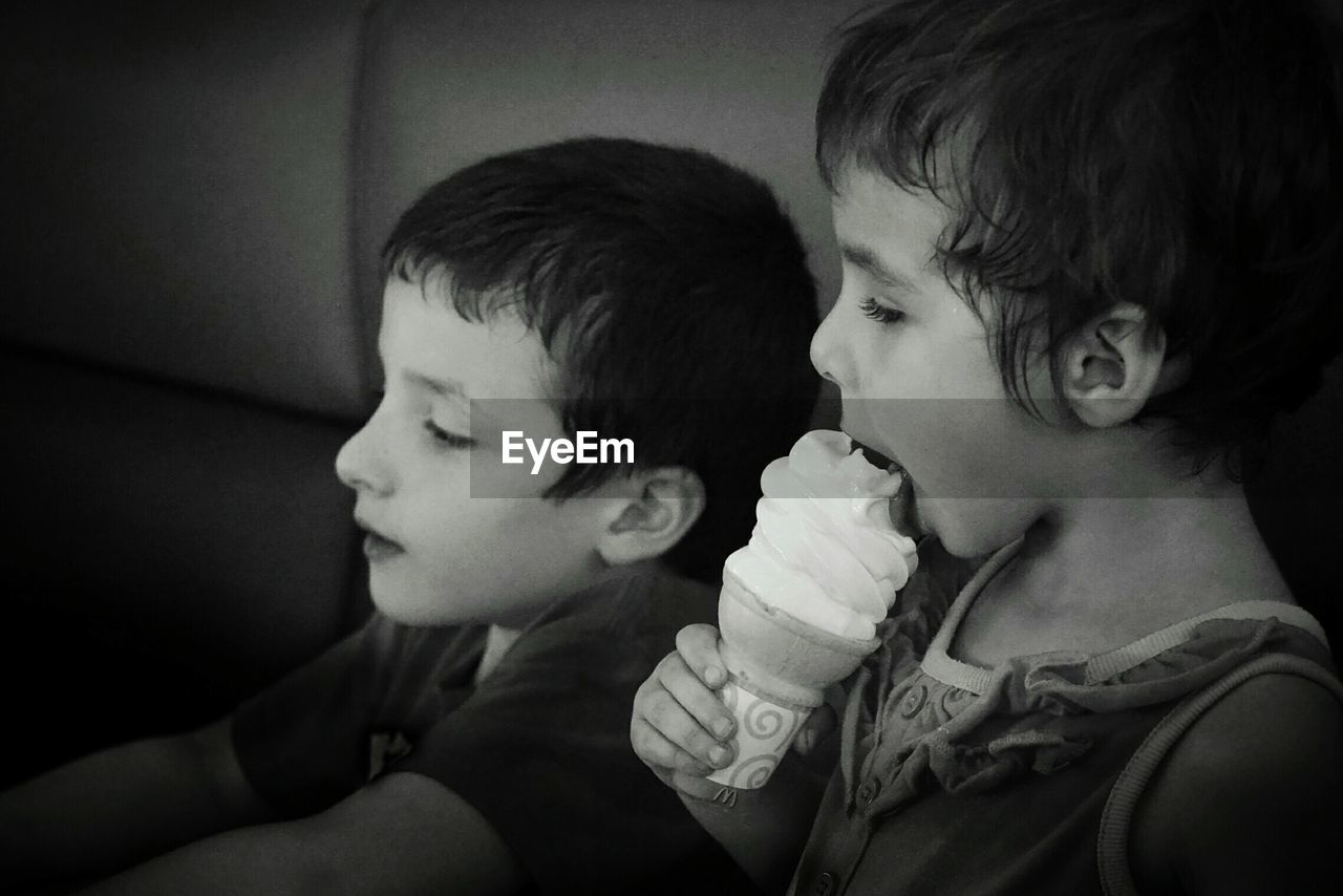 Side view of boy eating ice cream