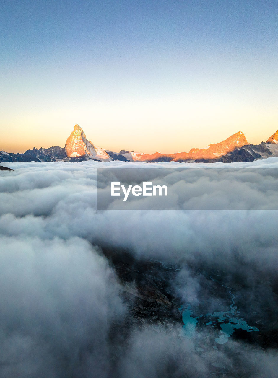 Sunrise at matterhorn, mountain above the clouds. swiss alps.