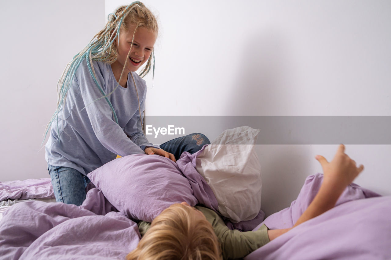 side view of woman lying on bed at home