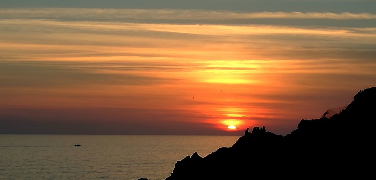 SCENIC VIEW OF SUNSET OVER SEA