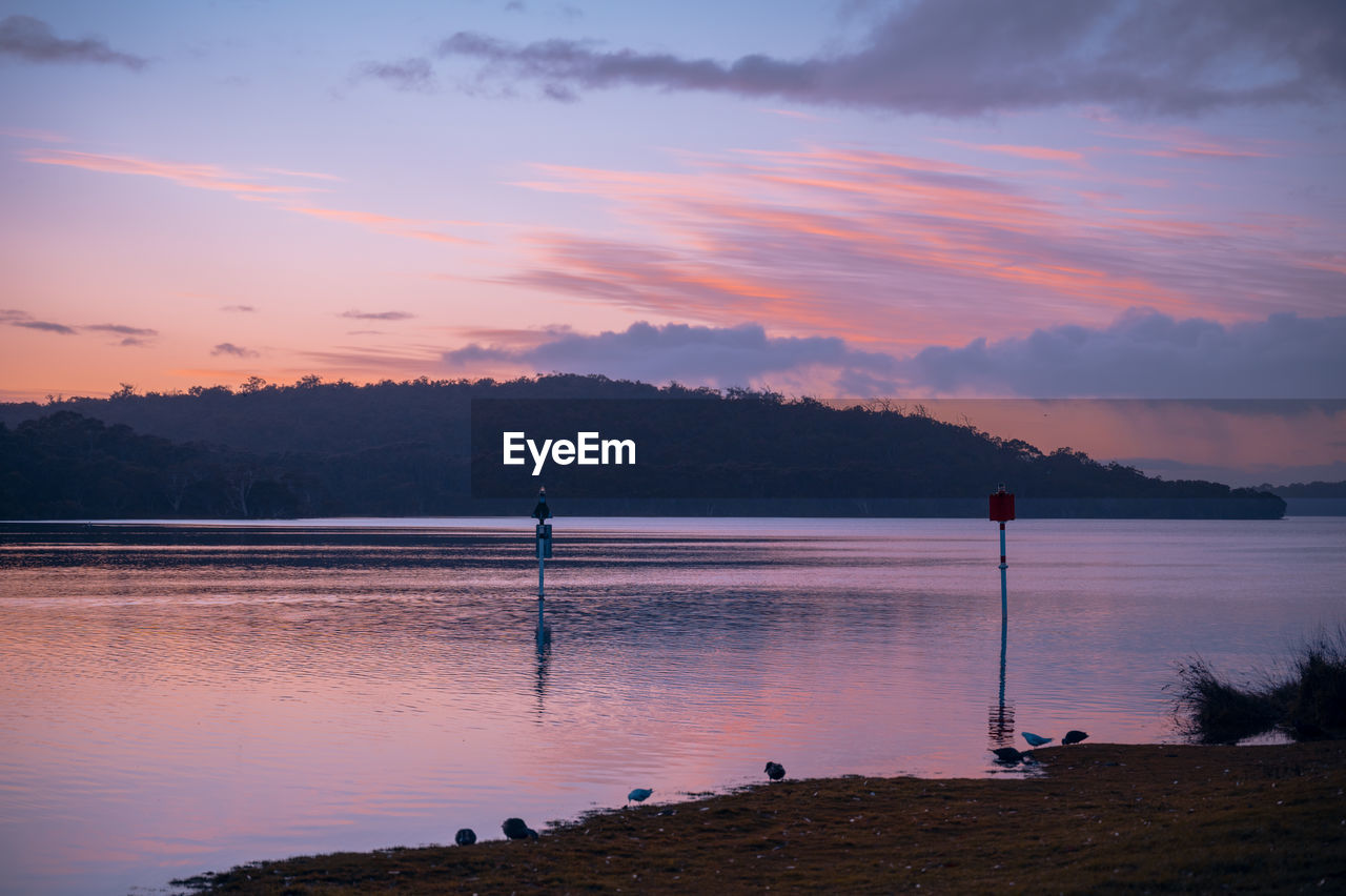 SCENIC VIEW OF LAKE AT SUNSET