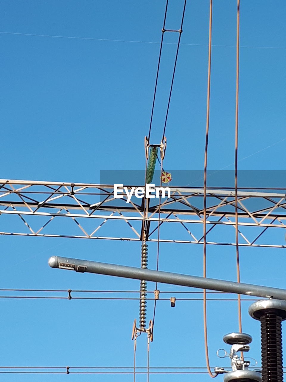 LOW ANGLE VIEW OF MEN WORKING AGAINST BLUE SKY