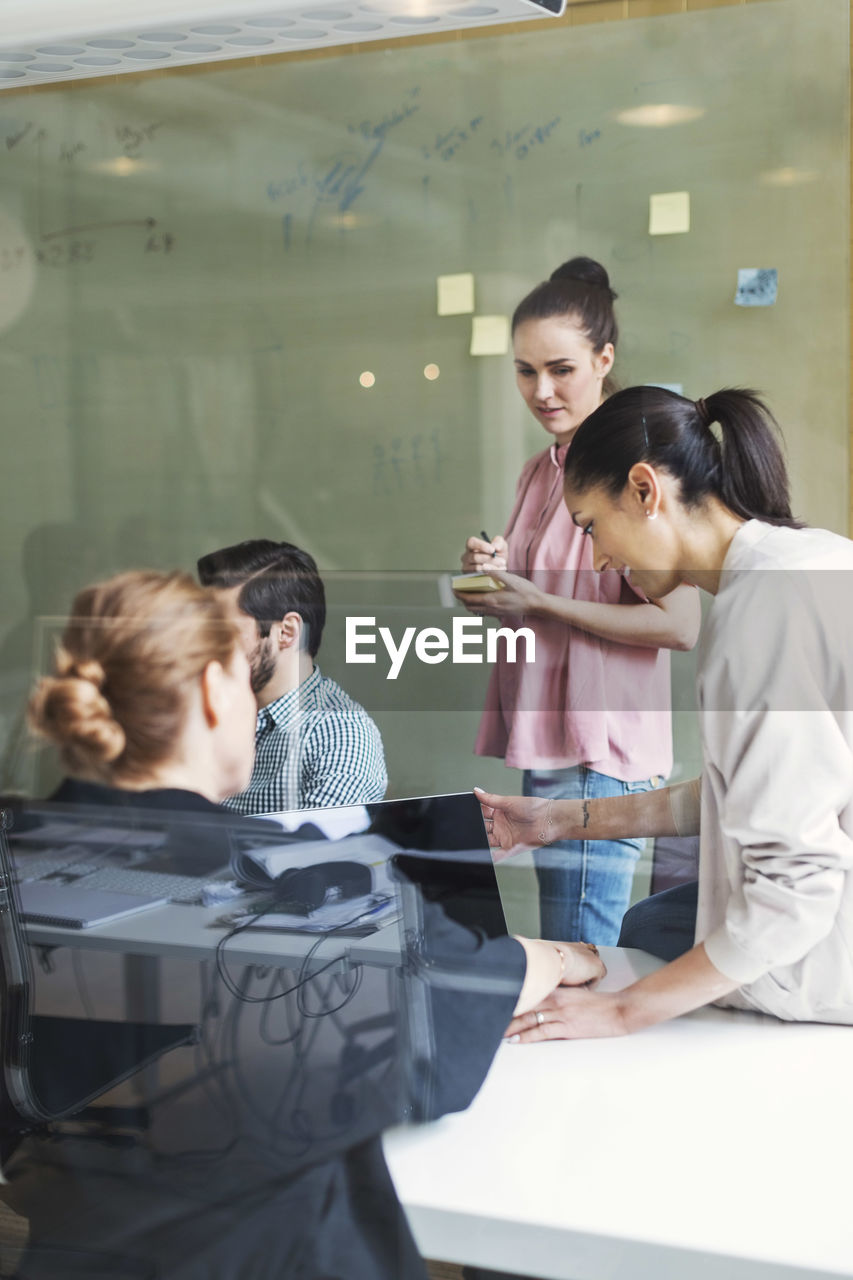 Team of business people having discussion in conference room