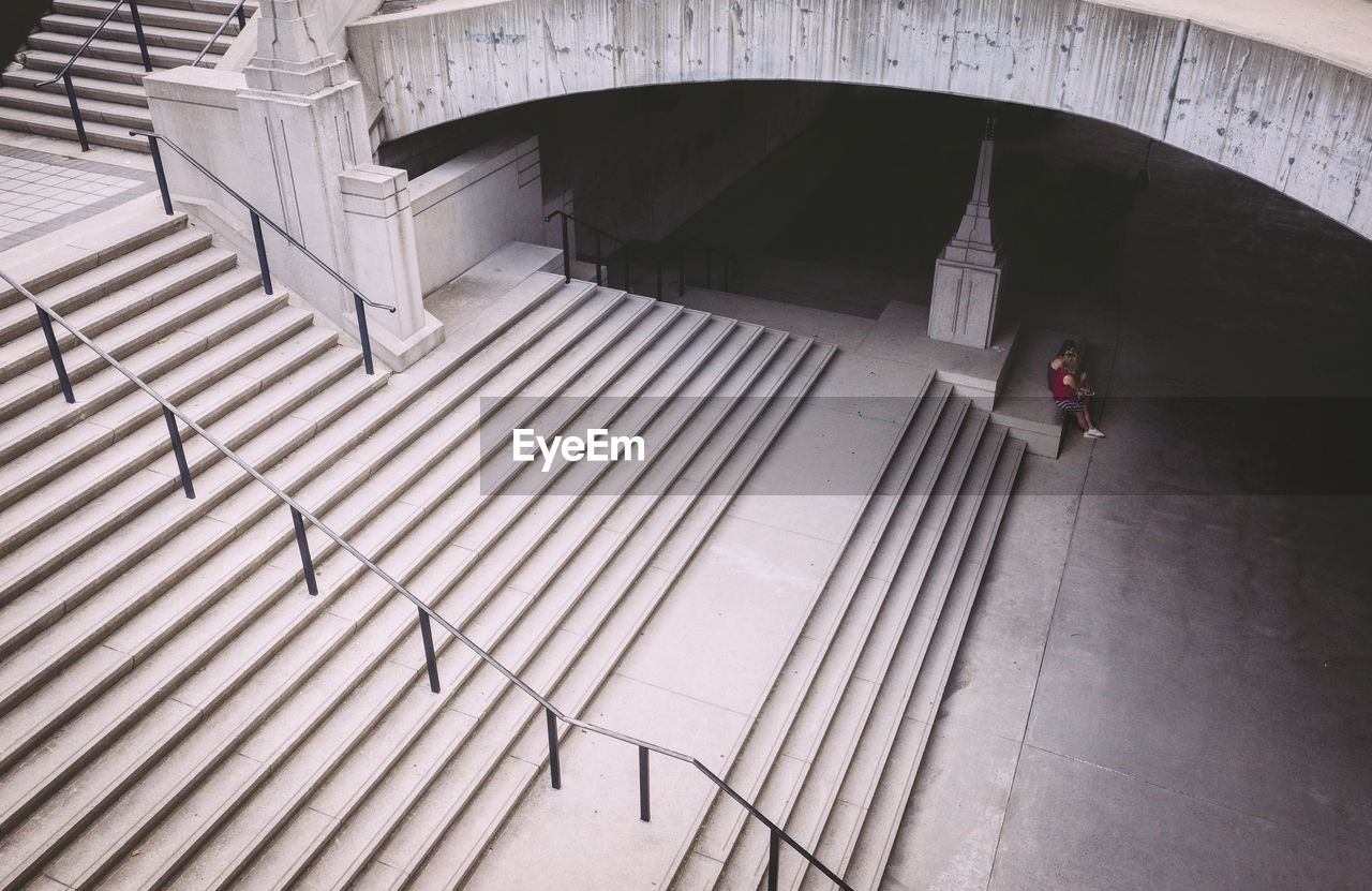 HIGH ANGLE VIEW OF MAN ON STEPS