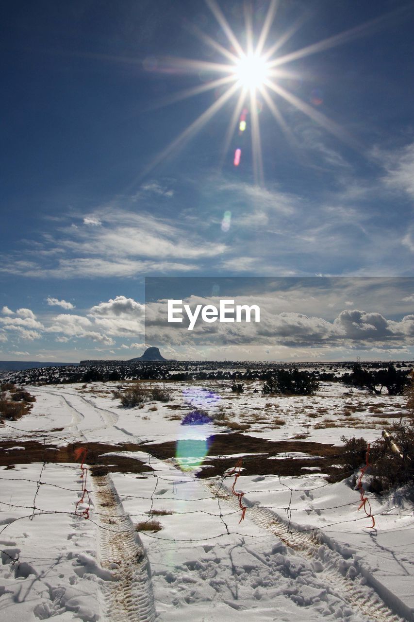 FROZEN LAKE AGAINST SKY ON SUNNY DAY