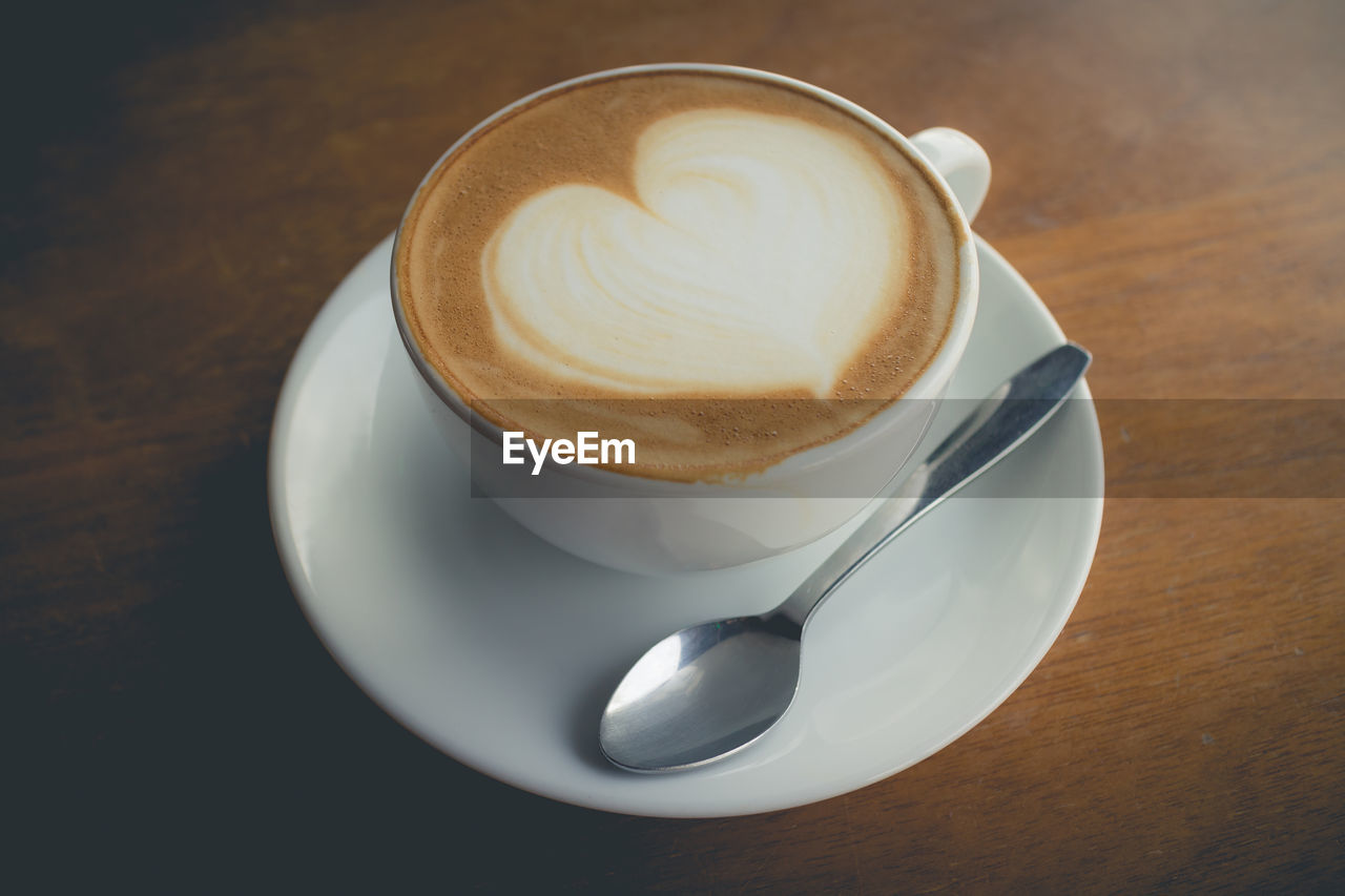 CLOSE-UP OF CAPPUCCINO ON TABLE