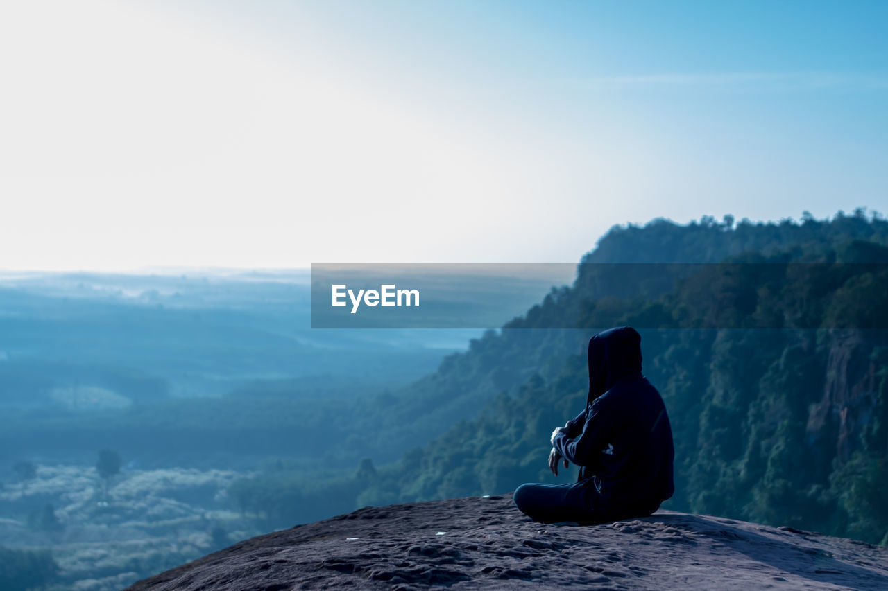 Man sitting on rock