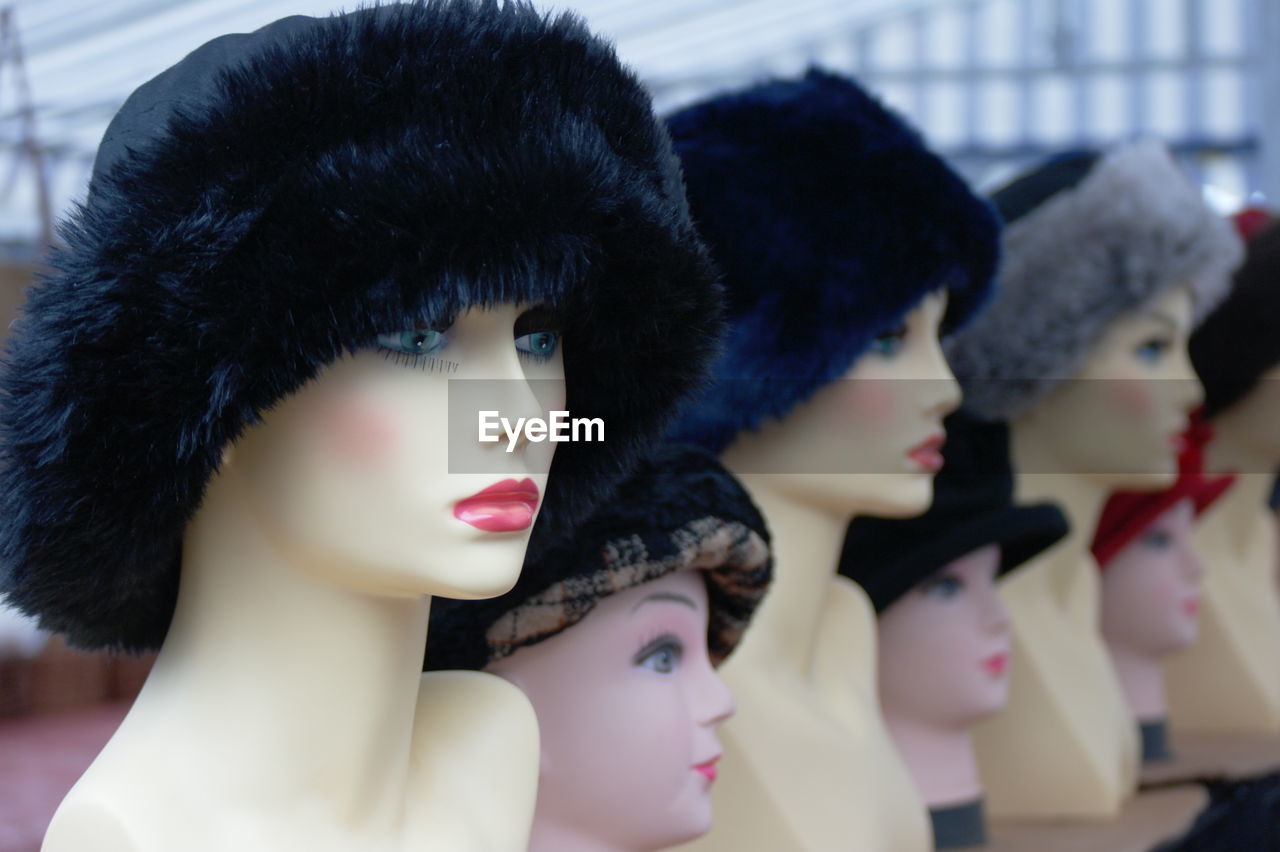 Close-up of fur hat on mannequins at store for sale