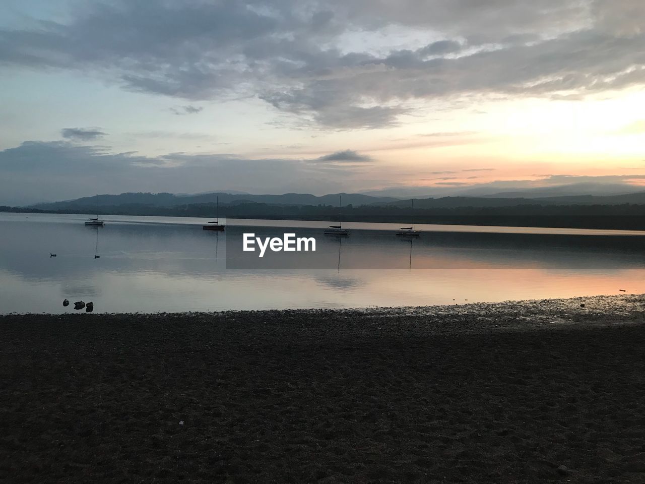 SCENIC VIEW OF LAKE AT SUNSET