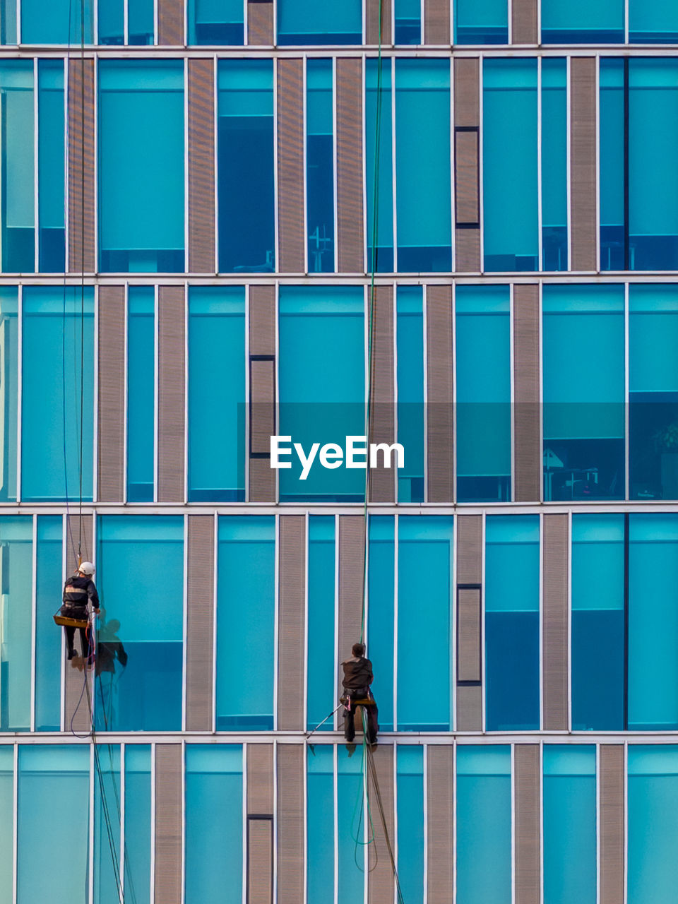 FULL FRAME SHOT OF BUILDING WITH BLUE GLASS WINDOW