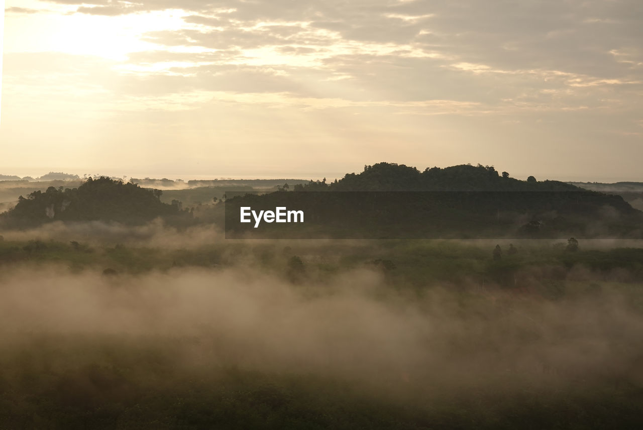 Scenic view of field against sky during sunset