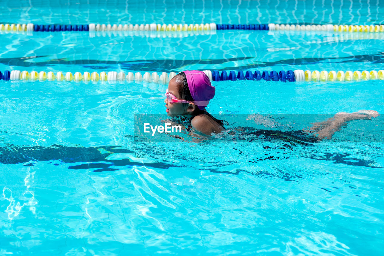 High angle view of girl swimming in pool