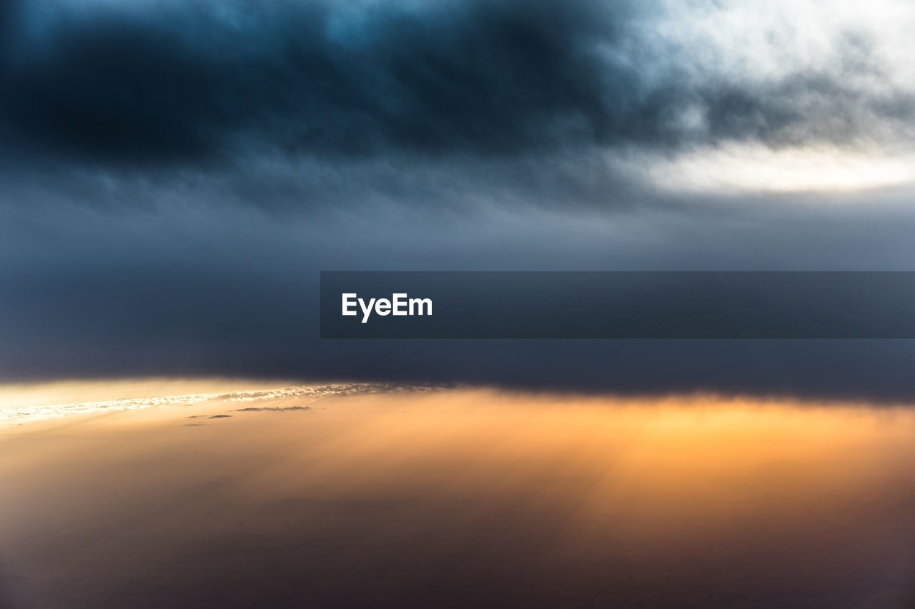 SCENIC VIEW OF STORM CLOUDS OVER SKY DURING SUNSET