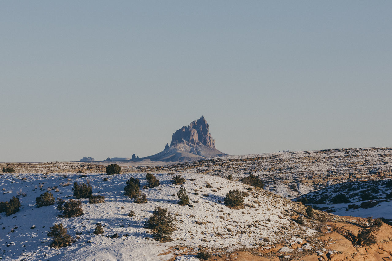 Scenic view of rock formation against clear sky during winter