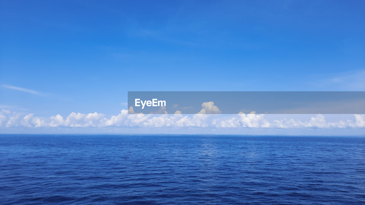 Scenic view of sea against blue sky