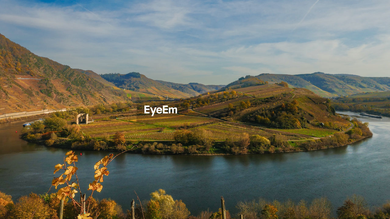 Scenic view of river moselle amidst mountains against sky
